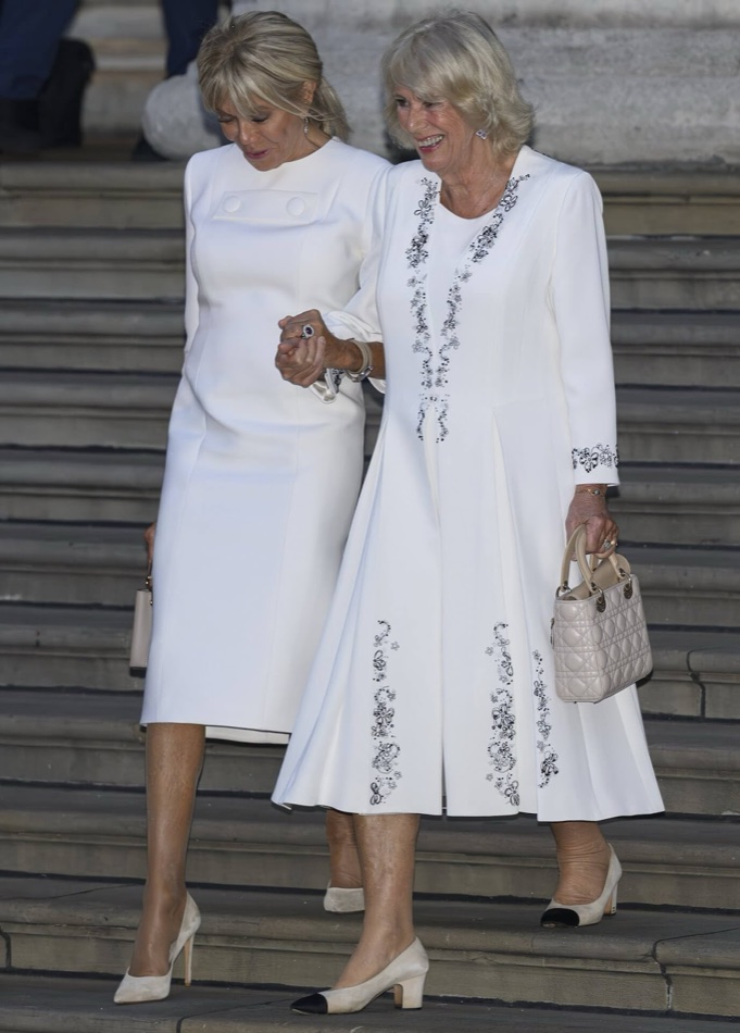Brigitte Macron and Queen Camilla walk hand in hand down the museum steps
