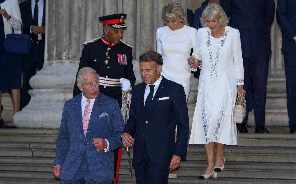 King Charles and President Macron walk down the steps first, with Brigitte Macron and Queen Camilla behind them
