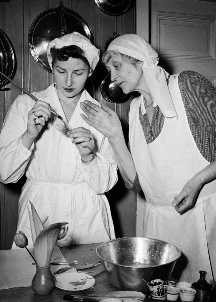 Princess Astrid stands at a kitchen counter with her teacher Lolly Ræstad