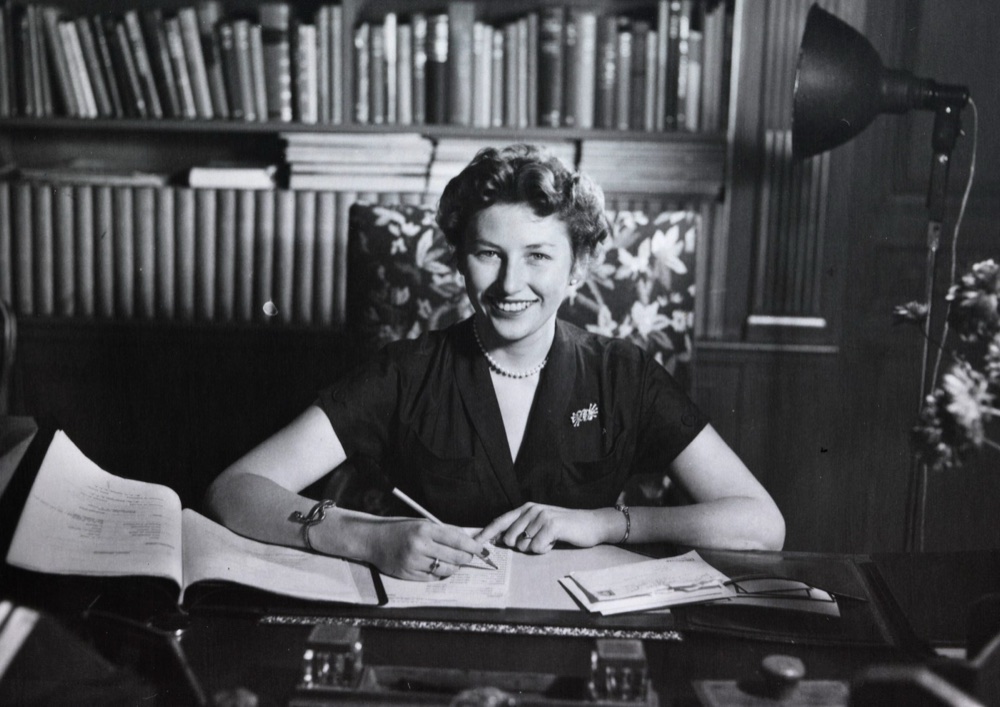 Princess Astrid sits at a desk with papers in front of her