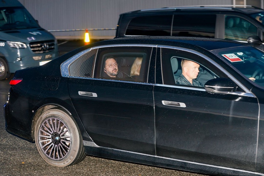 President Volodymyr Zelenskyy sits in the back seat of a black car driving away from the airport