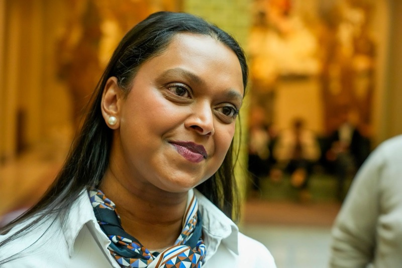Minister of Transport Kamzy Gunaratnam smiling in the parliament chamber