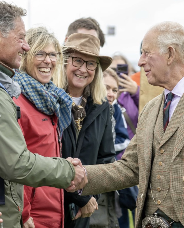 Kong Charles håndhilser på publikum