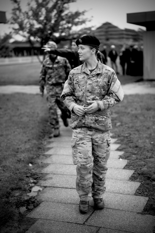 Black and white photograph of Princess Isabella in uniform walking along the path at the barracks