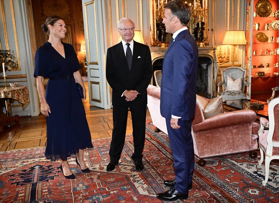 Kong Carl XVI Gustaf, kronprinsesse Victoria og president Emmanuel Macron i samtale i en salong på Kungliga slottet