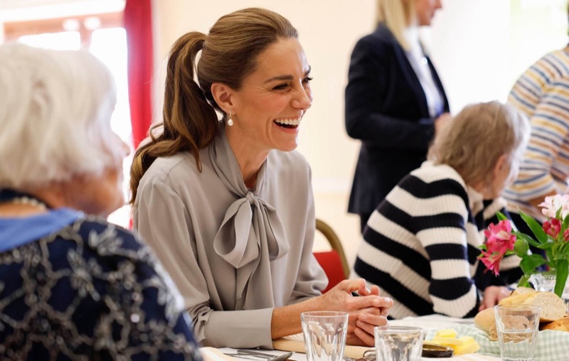 Princess Catherine laughs in conversation with the guests around the lunch table