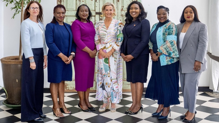 The Duchess of Edinburgh stands with six women in a line on a chequered floor