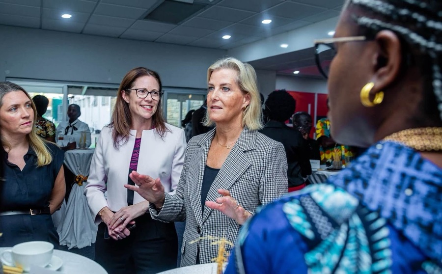 The Duchess of Edinburgh in conversation with several women in a meeting room, coffee cups on the table in front