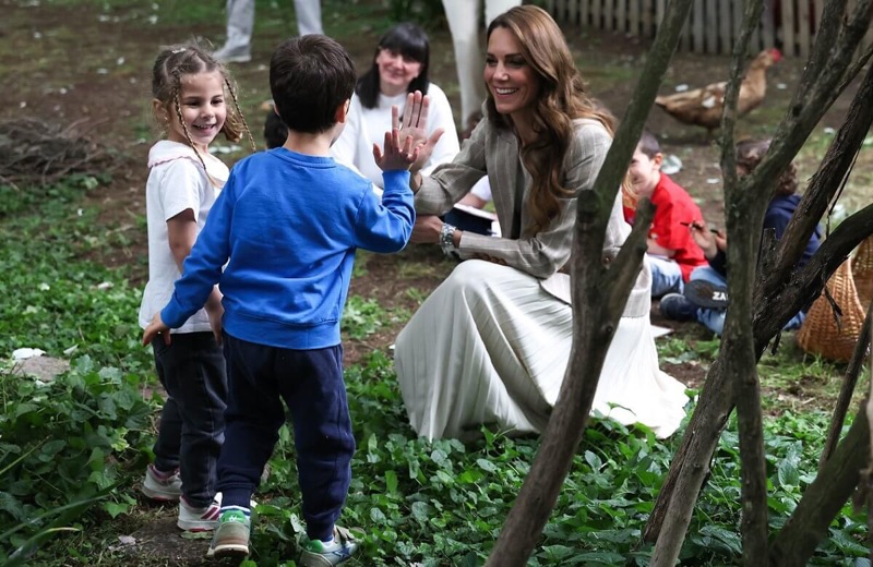 Prinsessen gir high-five til et barn